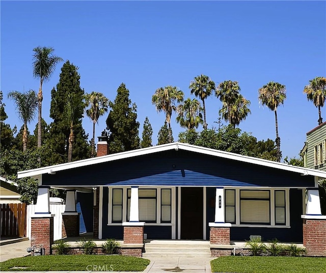 215 N Olive St, Anaheim, CA 92805 - view of front of property featuring covered porch and a chimney