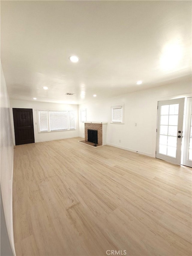 215 N Olive St, Anaheim, CA 92805 - unfurnished living room featuring light wood-style flooring, recessed lighting, and a fireplace