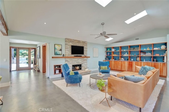 3163 Inclinado, San Clemente, CA 92673 - living area with a skylight, vaulted ceiling, a stone fireplace, concrete flooring, and ceiling fan