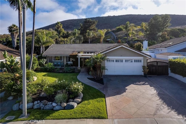 3163 Inclinado, San Clemente, CA 92673 - ranch-style house featuring an attached garage, concrete driveway, a mountain view, a tile roof, and a front yard