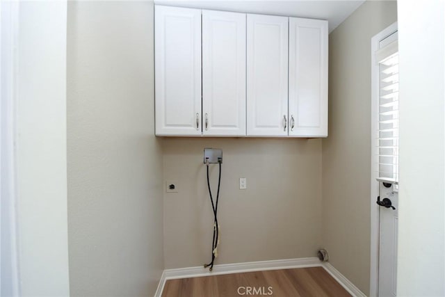 25981 Coombe Hill Dr, Menifee, CA 92586 - washroom featuring cabinet space, wood finished floors, washer hookup, and electric dryer hookup
