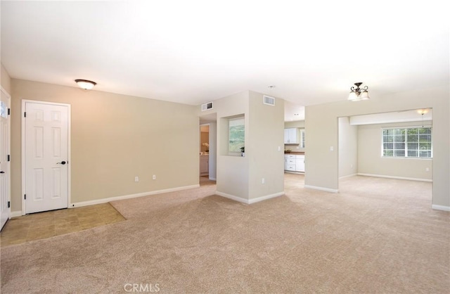 25981 Coombe Hill Dr, Menifee, CA 92586 - unfurnished living room featuring light colored carpet and baseboards