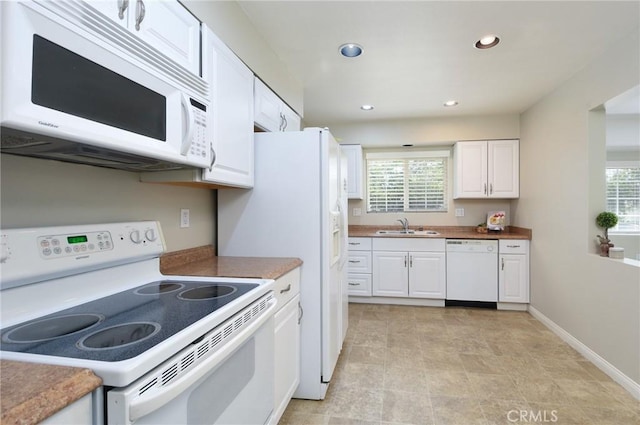 25981 Coombe Hill Dr, Menifee, CA 92586 - kitchen with white appliances, white cabinetry, healthy amount of natural light, and recessed lighting