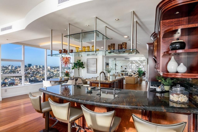 1325 Pacific Hwy Unit 3403, San Diego, CA 92101 - bar featuring plenty of natural light, wood finished floors, backsplash, and a view of city