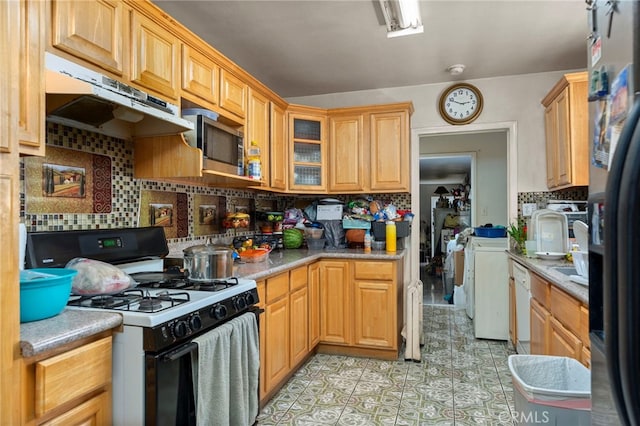 14057 Ohio St, Baldwin Park, CA 91706 - kitchen with gas stove, stainless steel microwave, under cabinet range hood, separate washer and dryer, and light countertops