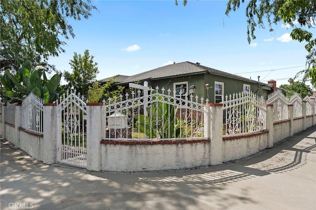 14057 Ohio St, Baldwin Park, CA 91706 - view of front facade with a fenced front yard, a gate, a shingled roof, and stucco siding