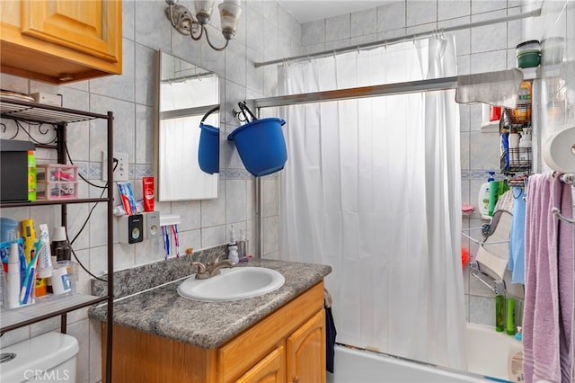 14057 Ohio St, Baldwin Park, CA 91706 - full bathroom featuring tile walls, decorative backsplash, vanity, and shower / bath combo with shower curtain