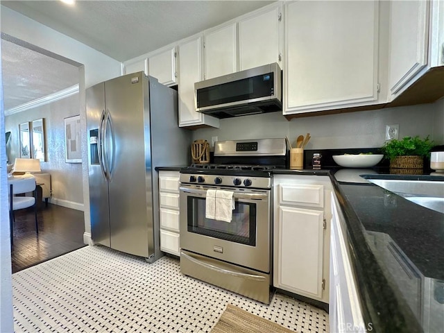 3845 Farquhar Ave Unit 212, Los Alamitos, CA 90720 - kitchen with stainless steel appliances, crown molding, and white cabinets
