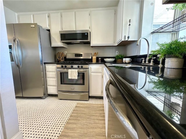3845 Farquhar Ave Unit 212, Los Alamitos, CA 90720 - kitchen featuring stainless steel appliances, white cabinets, and dark countertops