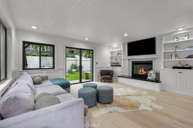 1012 10th St, Manhattan Beach, CA 90266 - living area with wood finished floors, a glass covered fireplace, built in shelves, recessed lighting, and wooden ceiling