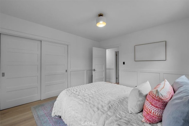 1012 10th St, Manhattan Beach, CA 90266 - bedroom featuring a decorative wall, a closet, wood finished floors, and wainscoting