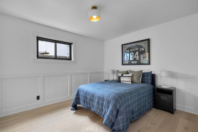 1012 10th St, Manhattan Beach, CA 90266 - bedroom with light wood finished floors, a decorative wall, and wainscoting