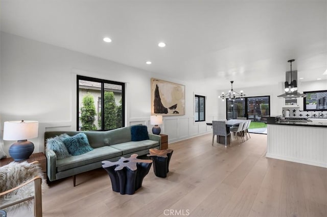 1012 10th St, Manhattan Beach, CA 90266 - living room featuring a chandelier, light wood finished floors, wainscoting, recessed lighting, and a decorative wall