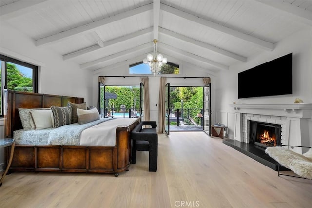 1012 10th St, Manhattan Beach, CA 90266 - bedroom featuring access to outside, light wood-style flooring, multiple windows, and a fireplace