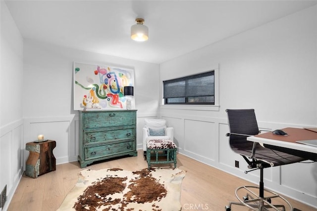 1012 10th St, Manhattan Beach, CA 90266 - home office featuring light wood-style flooring, a decorative wall, and wainscoting