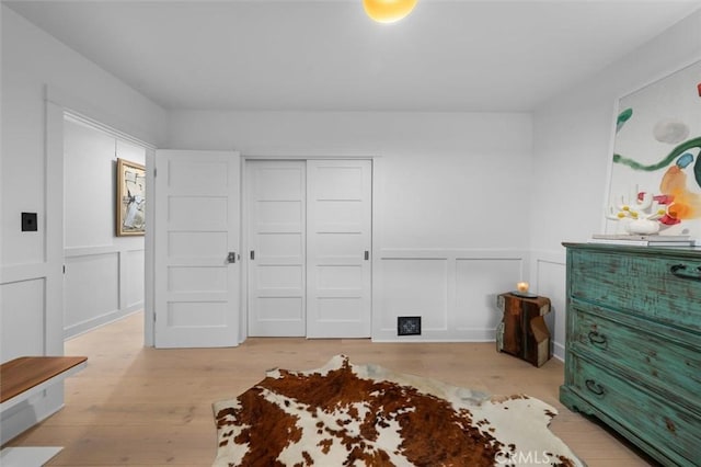 1012 10th St, Manhattan Beach, CA 90266 - bedroom featuring a decorative wall, wood finished floors, a wainscoted wall, and a closet