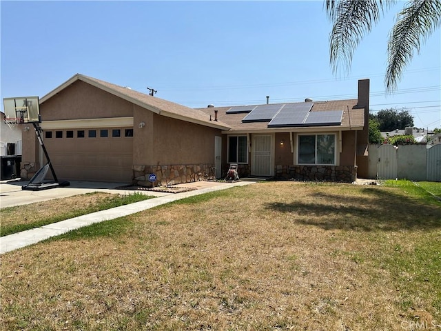 1424 Hunter Dr, Redlands, CA 92374 - single story home with stone siding, a gate, roof mounted solar panels, and a garage