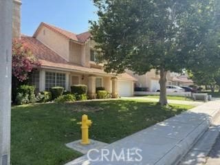 3054 Dearborn Ave, Palmdale, CA 93551 - view of front of property featuring a front yard and a garage