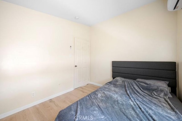 10224 Fernglen Ave, Tujunga, CA 91042 - bedroom featuring wood finished floors and an AC wall unit