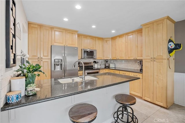 10270 Durango River Ct, Fountain Valley, CA 92708 - kitchen featuring appliances with stainless steel finishes, light brown cabinets, a peninsula, backsplash, and recessed lighting