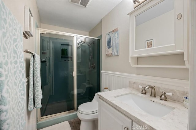 10270 Durango River Ct, Fountain Valley, CA 92708 - bathroom featuring vanity, a stall shower, wainscoting, and tile patterned floors