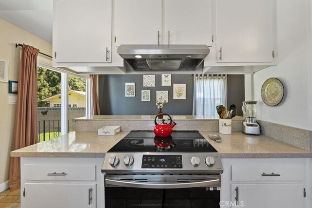 213 E 45th St, Long Beach, CA 90807 - kitchen with stainless steel electric range, extractor fan, and white cabinets