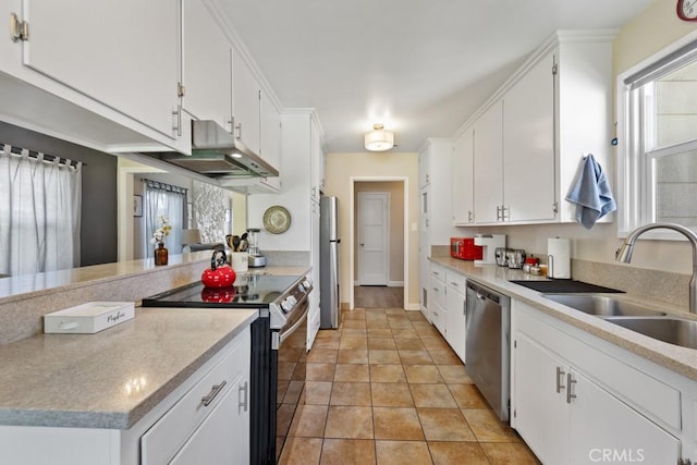 213 E 45th St, Long Beach, CA 90807 - kitchen with stainless steel appliances, white cabinetry, under cabinet range hood, and light countertops