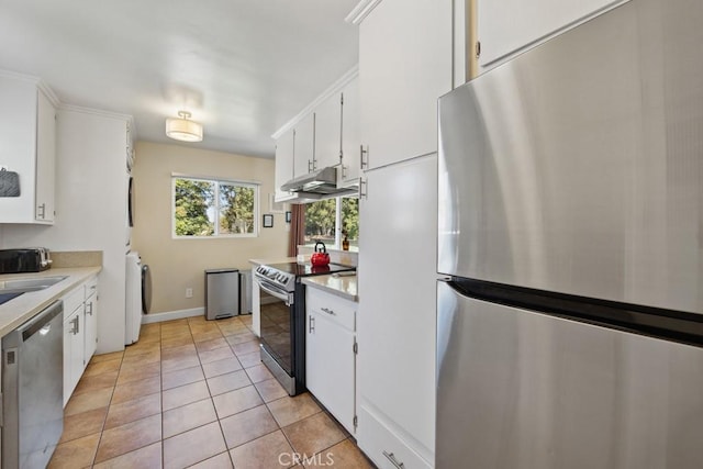 213 E 45th St, Long Beach, CA 90807 - kitchen with appliances with stainless steel finishes, light countertops, under cabinet range hood, and washer / clothes dryer
