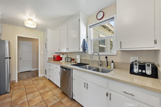 213 E 45th St, Long Beach, CA 90807 - kitchen with appliances with stainless steel finishes, white cabinetry, and light tile patterned flooring