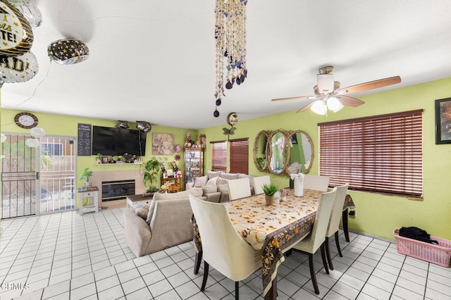 14134 Orizaba Ave, Paramount, CA 90723 - dining room featuring light tile patterned floors, ceiling fan, and a glass covered fireplace