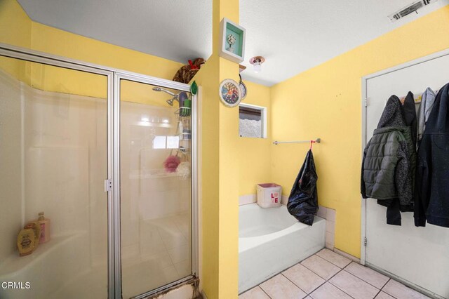 14134 Orizaba Ave, Paramount, CA 90723 - bathroom with tile patterned flooring, a bath, and a shower stall