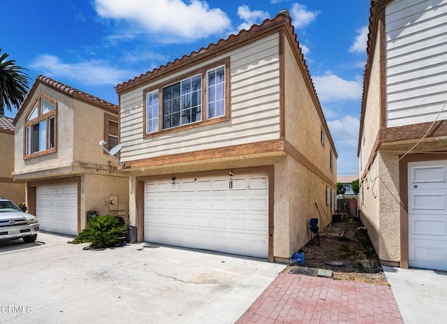 14134 Orizaba Ave, Paramount, CA 90723 - multi unit property featuring a garage, stucco siding, and concrete driveway