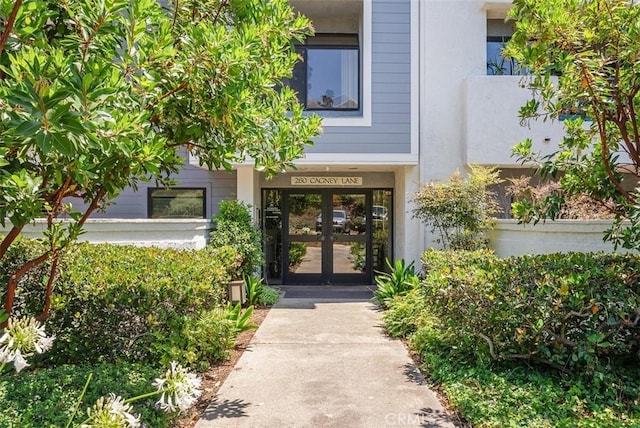 260 Cagney Ln Unit 206, Newport Beach, CA 92663 - view of exterior entry featuring french doors and stucco siding