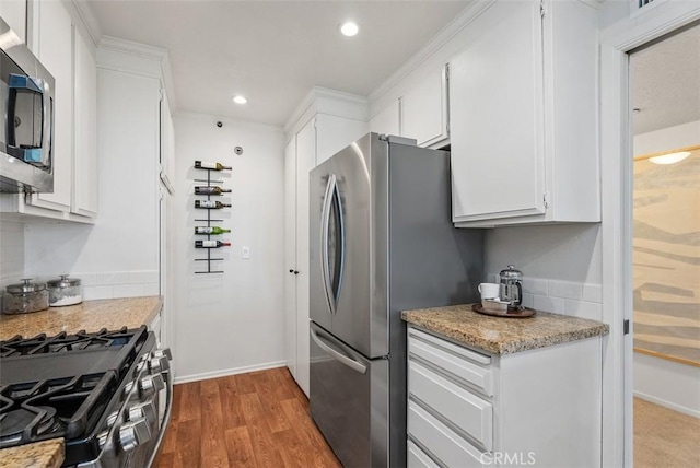 260 Cagney Ln Unit 206, Newport Beach, CA 92663 - kitchen with stainless steel appliances, white cabinetry, wood finished floors, recessed lighting, and light stone counters