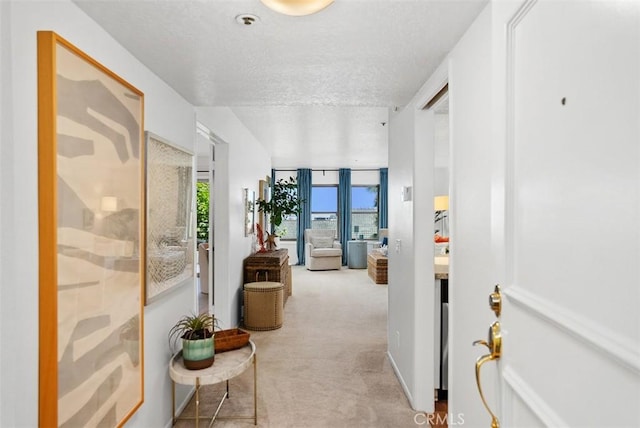 260 Cagney Ln Unit 206, Newport Beach, CA 92663 - hallway featuring a textured ceiling and carpet flooring