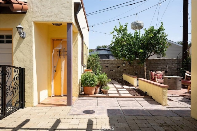 413 W Santa Clara Ave, Santa Ana, CA 92706 - view of exterior entry featuring stucco siding and a patio