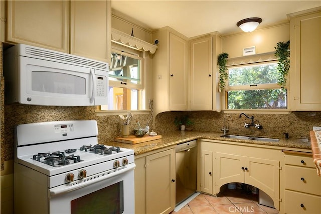 413 W Santa Clara Ave, Santa Ana, CA 92706 - kitchen with white appliances, backsplash, light tile patterned flooring, light stone counters, and cream cabinetry