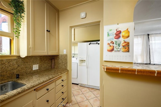 413 W Santa Clara Ave, Santa Ana, CA 92706 - kitchen featuring white refrigerator with ice dispenser, washer / dryer, light tile patterned flooring, decorative backsplash, and ornamental molding