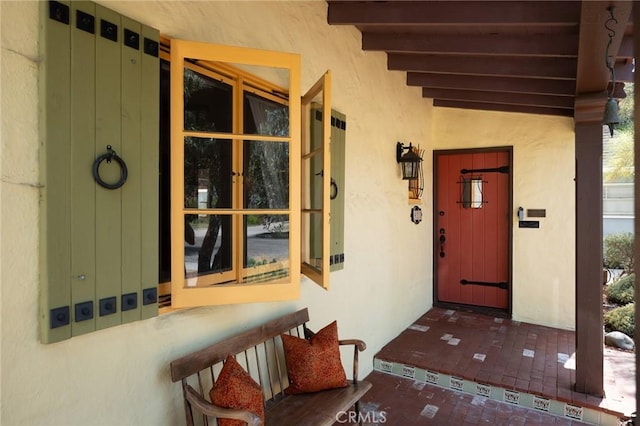 413 W Santa Clara Ave, Santa Ana, CA 92706 - doorway to property with stucco siding and a porch