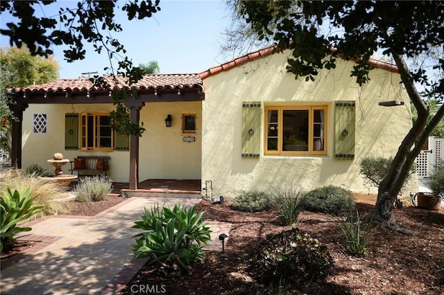 413 W Santa Clara Ave, Santa Ana, CA 92706 - mediterranean / spanish-style home featuring a tiled roof, stucco siding, and covered porch