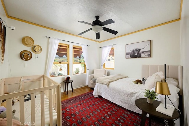 413 W Santa Clara Ave, Santa Ana, CA 92706 - bedroom with wood finished floors, ceiling fan, crown molding, and a textured ceiling