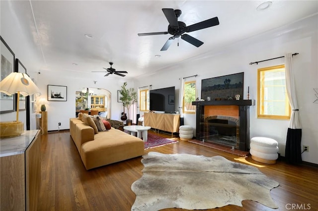413 W Santa Clara Ave, Santa Ana, CA 92706 - living area featuring wood finished floors, a fireplace with raised hearth, and a ceiling fan