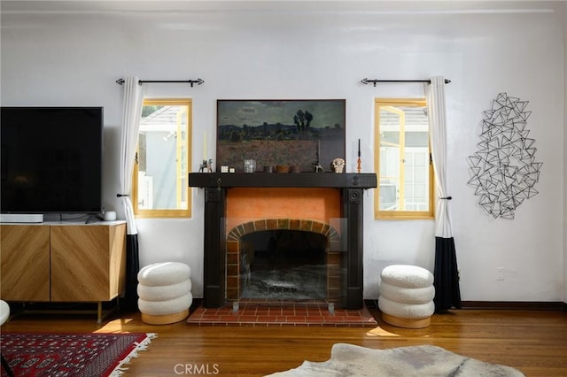 413 W Santa Clara Ave, Santa Ana, CA 92706 - living room featuring wood finished floors, a fireplace, and healthy amount of natural light