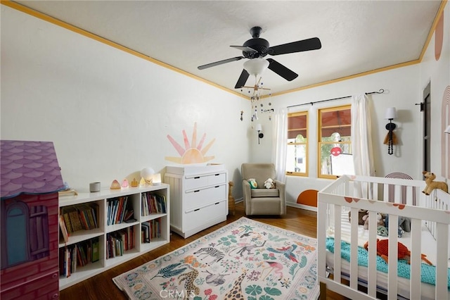 413 W Santa Clara Ave, Santa Ana, CA 92706 - bedroom with wood finished floors, a crib, and ceiling fan