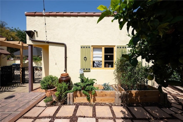 413 W Santa Clara Ave, Santa Ana, CA 92706 - rear view of property featuring stucco siding and a patio
