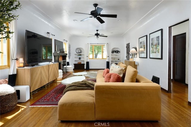 413 W Santa Clara Ave, Santa Ana, CA 92706 - living area with wood finished floors, ceiling fan, a fireplace, and built in features