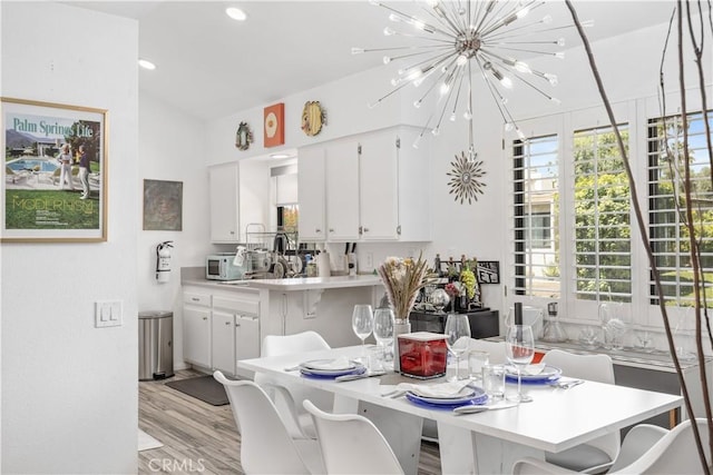 2455 Via Sonoma Unit A, Palm Springs, CA 92264 - dining area with a chandelier, light wood-style flooring, recessed lighting, and lofted ceiling