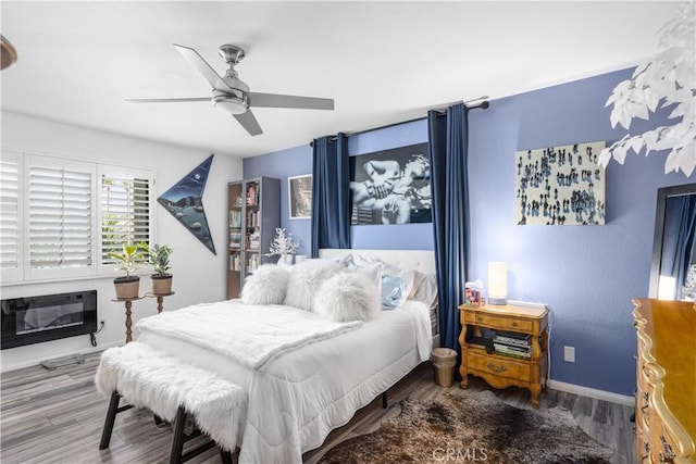 2455 Via Sonoma Unit A, Palm Springs, CA 92264 - bedroom featuring wood finished floors, a ceiling fan, and a glass covered fireplace