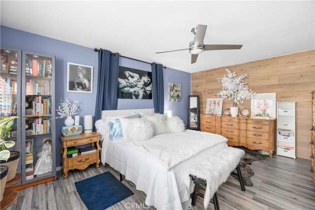 2455 Via Sonoma Unit A, Palm Springs, CA 92264 - bedroom featuring wood finished floors, wooden walls, and a ceiling fan
