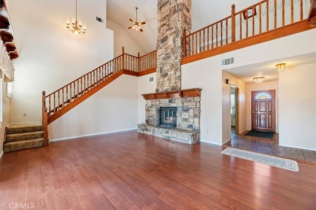29801 Maxine Ln, Menifee, CA 92584 - unfurnished living room with wood finished floors, stairway, ceiling fan, high vaulted ceiling, and a stone fireplace